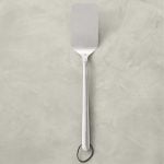 Williams Sonoma Stainless Steel Handled BBQ Turner on a light gray surface