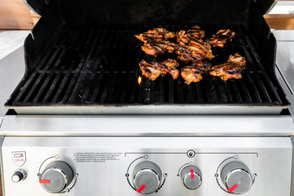 Bulgogi marinated chicken thighs grill over direct heat on a Weber gas grill to create grilled chicken bulgogi.