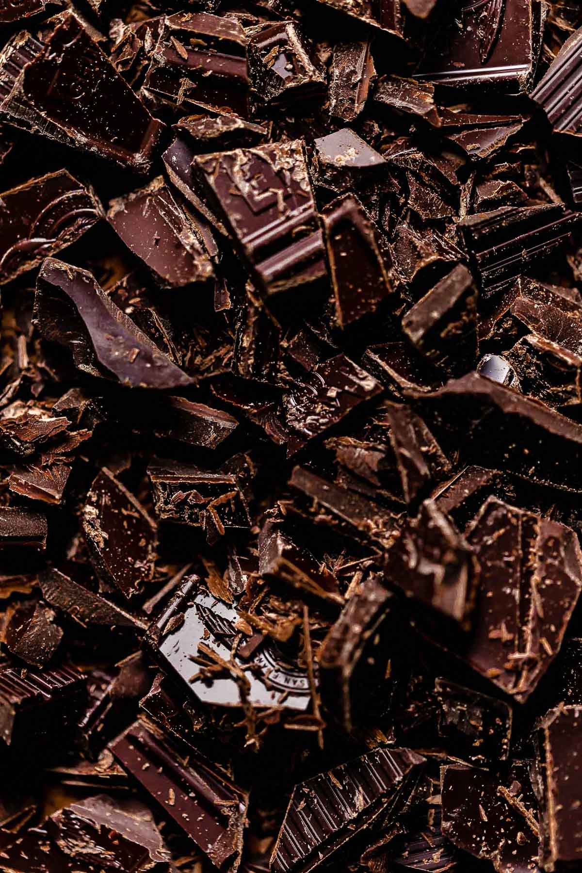 A close up macro shot of chopped bittersweet chocolate.