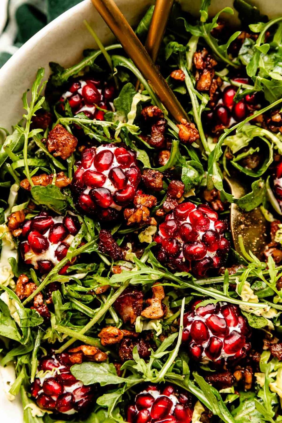 A close-up overhead shot of Christmas salad in a white bowl.