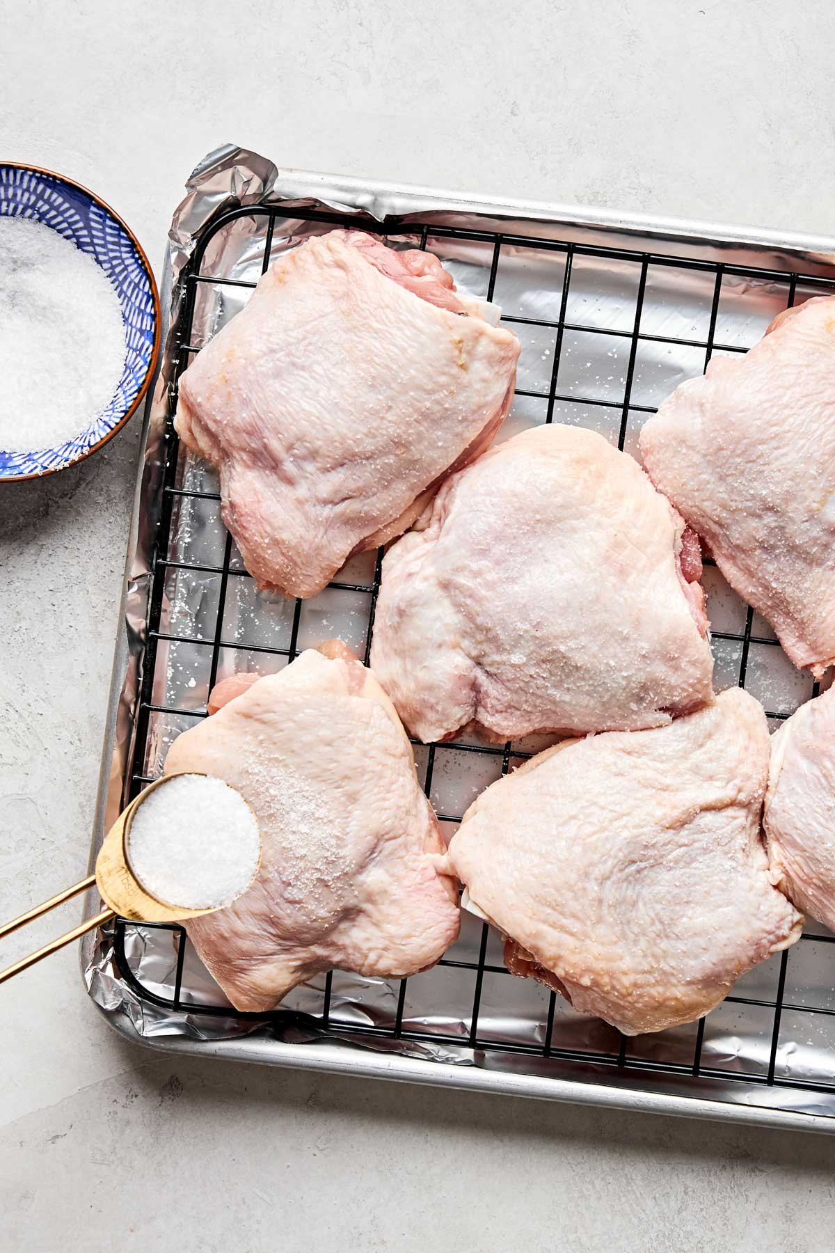 A tray of raw chicken thighs.
