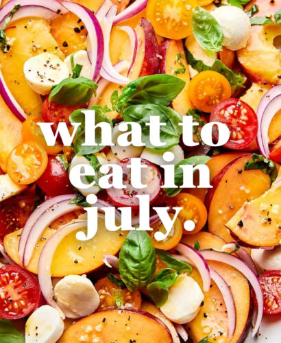 A colorful summer salad with sliced peaches, cherry tomatoes, red onion, mozzarella balls, and fresh basil leaves. White text overlay reads: what to eat in july.