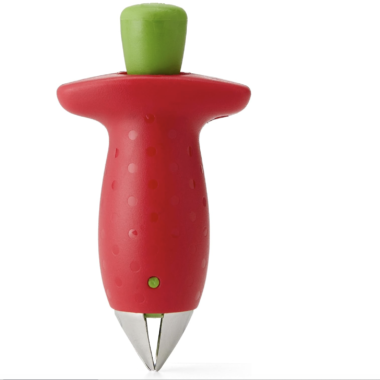 A strawberry-shaped kitchen tool with a red handle, green button top, and metal prongs at the bottom, designed for removing strawberry stems.